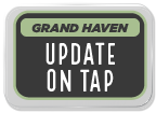 Sign for Grand Haven with the text 'Update on Tap' in a bold font.