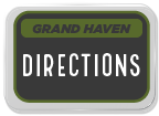 Sign indicating directions to Grand Haven with a clear and bold design.
