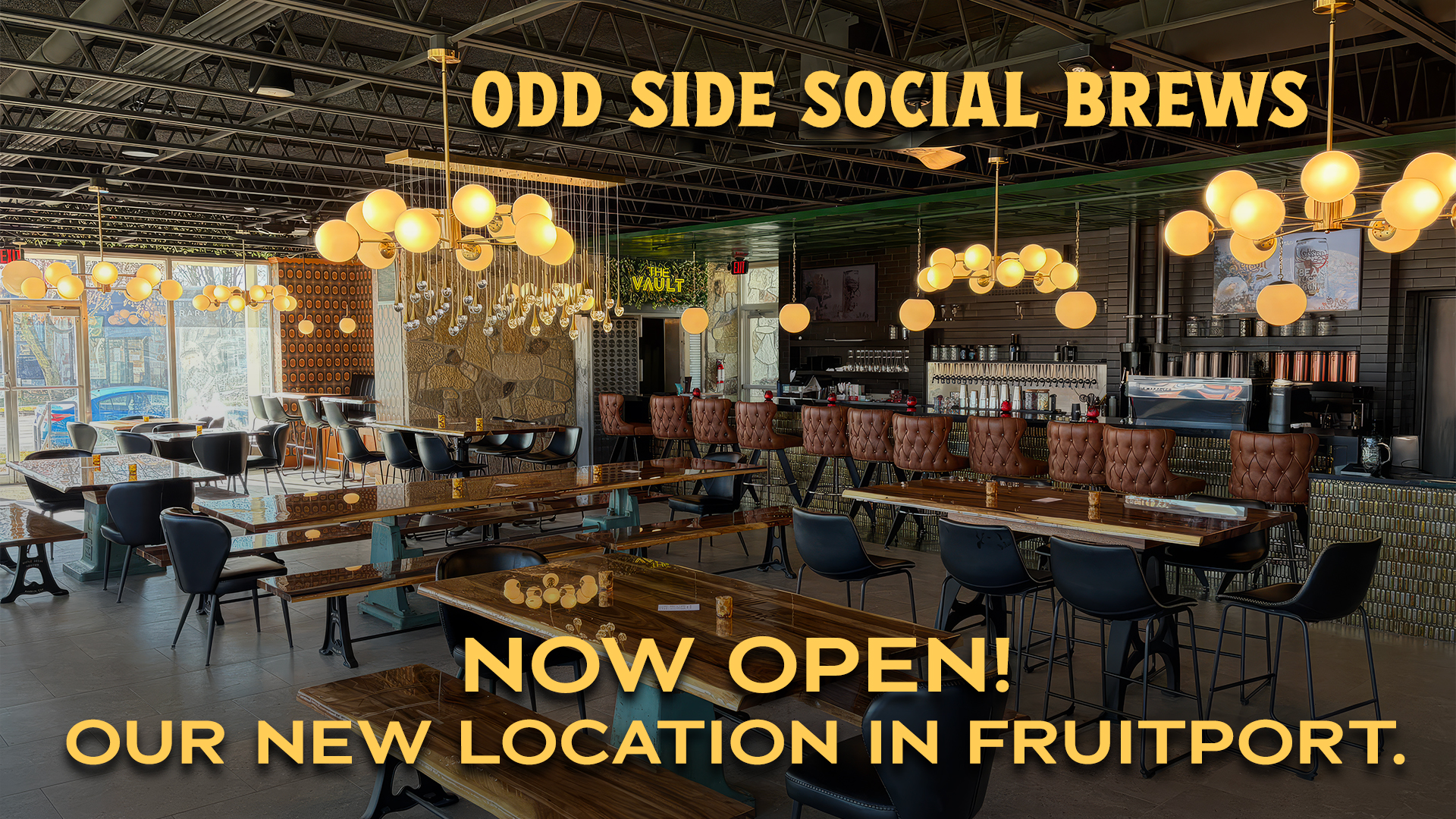 Interior view of Odd Side Social Brews with wooden tables and pendant lighting in Fruitport.